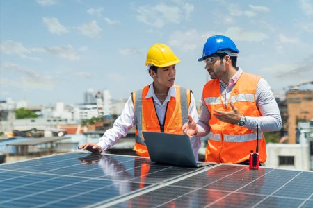 Photo for Solar panel technician on roof. Engineer and Young technician discussing project with laptop of solar power station. - Royalty Free Image