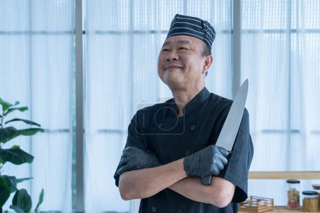 Téléchargez les photos : The Asian man with kitchen knife presenting a set of sashimi. Working hours in sushi bar. Happy proud Asian chef smiling. - en image libre de droit