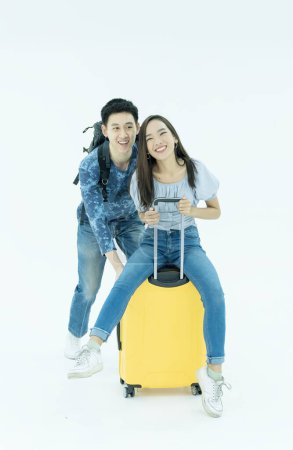 Photo for Young Couple traveler with luggage on white background. Man and girl preparing for vacation. Asian Couple traveler with luggage isolated on white - Royalty Free Image