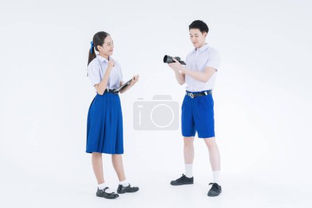 Photo for Student looking image on dslr camera screen. Boy and girl. Friends and education. Students with tablet. Director. - Royalty Free Image