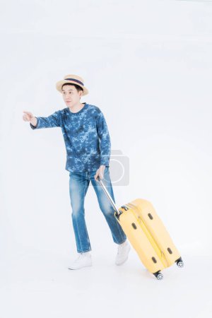 Photo for Young traveler with luggage on white background. Young man with suitcase isolated on white. - Royalty Free Image