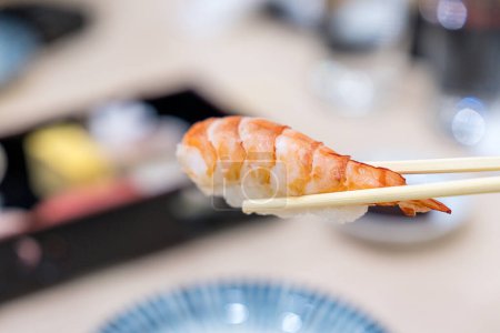 Foto de Set de sushi japonés. Sushi de camarones en palillos. - Imagen libre de derechos