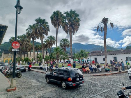 Photo for Antigua, Guatemala - November 16th of 2022: Main view of Parque Unin square, one of the most typical spots of Antigua Guatemala where locals chat and rest and vendors sell handcraft products and food - Royalty Free Image