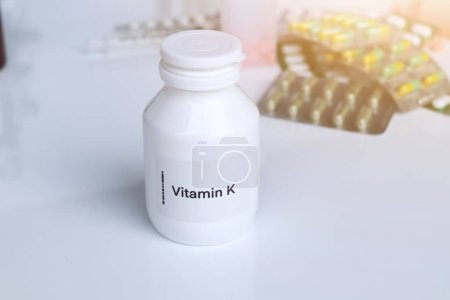 Photo for Vitamin K pills in a bottle, food supplement for health or used to treat disease - Royalty Free Image