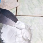 mixing grout in a bucket for mechanic work or repair