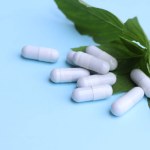 herbal pills or vitamins and green leaf, bio supplement, eco friendly