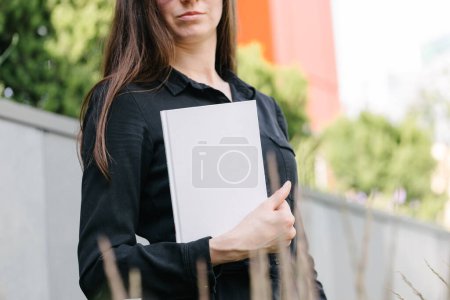 Photo for White book cover in woman's hands. Book cover for mock up - Royalty Free Image