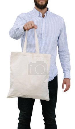 Foto de Joven sosteniendo bolso ecológico textil blanco. Bolso ecológico blanco para maqueta aislado sobre fondo blanco - Imagen libre de derechos