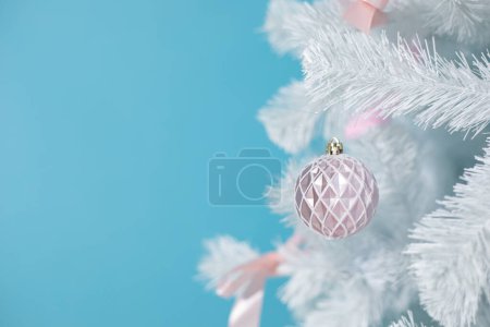 Photo for Christmas card with white christmas tree with beautiful decorations and toys. Artificial fir or pine tree on blue background with copy space, place for text. New year, holiday symbol, winter. - Royalty Free Image