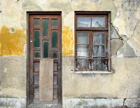 Photo for Old, abandoned house with cracked walls and peeling plaster. Braga, Portugal. - Royalty Free Image