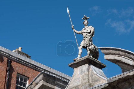 Photo for Statue of Fortitude with spear and lion on the gate of Dublin castle in Ireland, sculpted in 1753. - Royalty Free Image