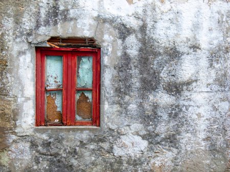 Photo for Boarded up window of old, abandoned house with peeling paint and moldy walls. - Royalty Free Image