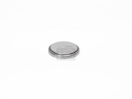 CR2032 button cell battery close up on a white background.
