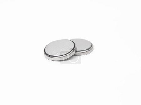 Two CR2032 button cell lithium batteries on a white background. Close up.