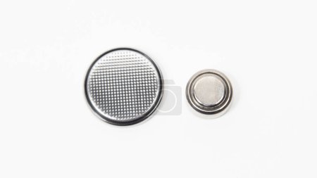 LR44 and CR2032 button cell batteries on a white background. Close up.