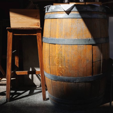 Photo for Wooden Wine Barrel and Tall Bar Chair. - Royalty Free Image