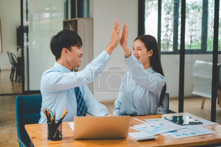 Photo for Business people are happy and give each other high fives. After success in doing business - Royalty Free Image