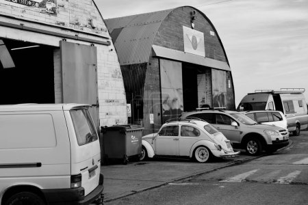 Photo for Barry, Vale of Glamorgan, Wales 02 Feb 2024: Many of the industrial lockups  on Barry docks are used for autobody repairs and many vintage cars are stored around the units - Royalty Free Image