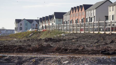 Photo for Barry, Vale of Glam, Wales Feb 02 2024: East Quay, The Waterfront. New site being landscaped. Homes are very close to the perimeter of industrial dockland and controversial bio chemical incinerator. - Royalty Free Image