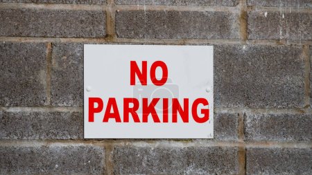 No parking signs on industrial units due to access requirements for industrial units. Red  letters on white background,