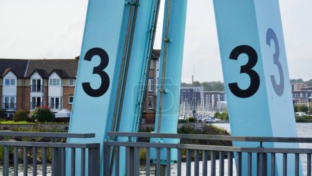 Cardiff Bay, Cardiff, Wales Sept 25 2023: Large black numbers 1, 2 and 3 are painted above the locks on the  Cardiff Barrage. The locks allow small boats to enter from Cardiff Bay at high tide.