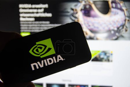 Photo for Rheinbach, Germany  28 November 2022,  The brand logo of the developer of graphics processors and chipsets "Nvidia" on the display of a smartphone in front of the website (focus on the brand logo) - Royalty Free Image