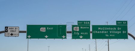 signs on the Santan Freeway, 202 Loop East in Chandler, Arizona for HOV lane, Exit 50A 101 Loop North, and Exit 51 McClintock Dr and Chandler Village Drive