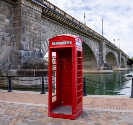 Photo for Traditional British red telephone booth by London Bridge in Lake Havasu City, Arizona is a popular spot for a selfie. - Royalty Free Image