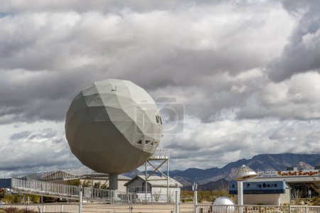 Photo for Yucca, AZ - March 11, 2023: 40 ft diameter Geodesic Dome sits by the side of Interstate 40 with a sign for the Arizona Proving Ground for Ford Motor Company and a restaurant called Rocket Burger. - Royalty Free Image