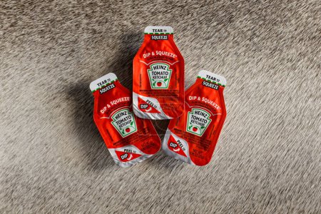 Photo for Chandler, AZ - Nov. 24, 2023: Dip and Squeeze style single serve packets of Heinz Tomato Ketchup - Royalty Free Image