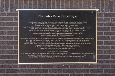 Photo for History of the Tulsa Race Riot of 1921 on a wall at the John Hope Franklin Reconciliation Park - Royalty Free Image