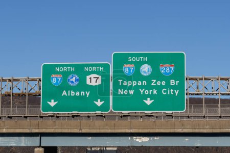 Photo for Mahwah, NJ - Feb. 27, 2022: Exit signs on  I-287, NJ-17 for I-87 New York State Thruway North toward Albany, and South toward Tappan Zee Bridge, AKA Governor Mario M. Cuomo Bridge, and New York City. - Royalty Free Image