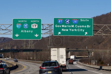 Photo for Suffern, NY - Feb 27, 2022: Exit signs on I-287 for I-87 New York State Thruway North toward Albany and NY-17, and South toward Governor Mario M. Cuomo Bridge, AKA Tappan Zee Bridge and New York City - Royalty Free Image
