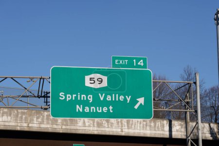 Photo for Sign on I-287 I-87 NY State Thruway in Nanuet, New York for Exit 14 for NY-59 to Spring Valley and Nanuet - Royalty Free Image