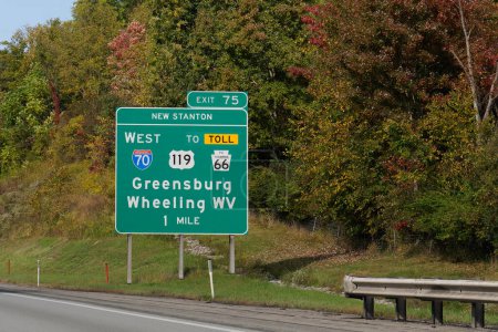 Photo for Exit 75 sign for Greensburg, Pennsylvania and Wheeling, West Virginia via I-70, US-119 and PA-66, the Amos K Hutchinson Bypass toll road - Royalty Free Image