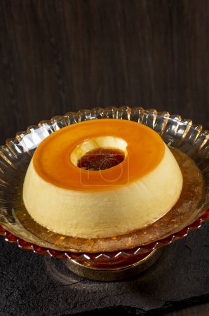 Photo for Creamy caramel custard pudding on a dark wooden background. - Royalty Free Image
