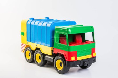 Photo for Multi-colored plastic toy trucks for childrens games on a white background. Garbage truck. - Royalty Free Image