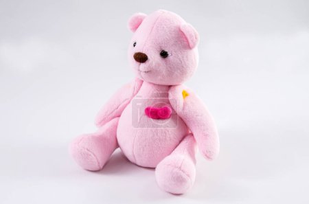 Pink cute teddy bear on a white background.