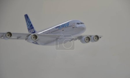 Photo for Aircraft model A380 miniature with white and blue paint. White background and base. Copy space. side view - Royalty Free Image