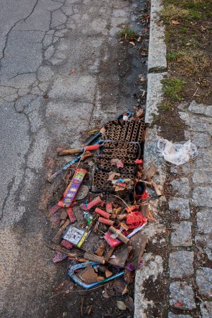 Photo for Berlin, Germany - January 1, 2022: Various remains of a New Year's Eve celebration on the sidewalk of a street. - Royalty Free Image