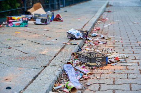 Photo for Berlin, Germany - January 1, 2023: Various remains of a New Year's Eve celebration along a street. - Royalty Free Image