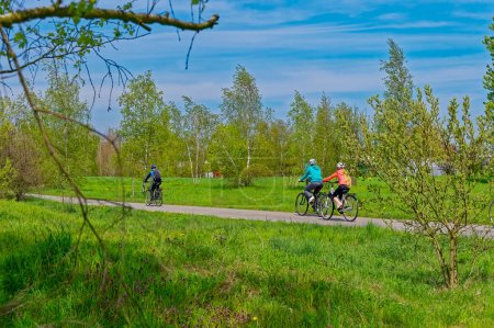 Photo for Three cyclists from behind on the Berlin Wall Trail. - Royalty Free Image