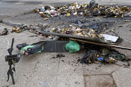 Photo for Remains of an e-scooter and rubbish on New Year's Day following vandalism and arson. - Royalty Free Image