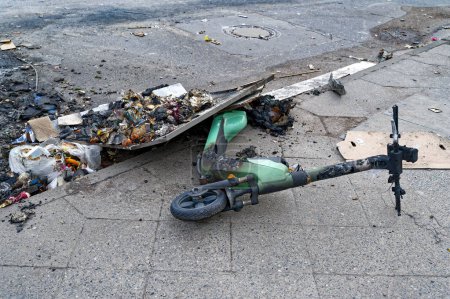 Photo for Remains of an e-scooter and rubbish on New Year's Day following vandalism and arson. - Royalty Free Image