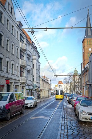 Photo for Berlin, Germany - January 19, 2024: Street scene in Berlin-Koepenick with a streetcar in front of historic buildings. - Royalty Free Image