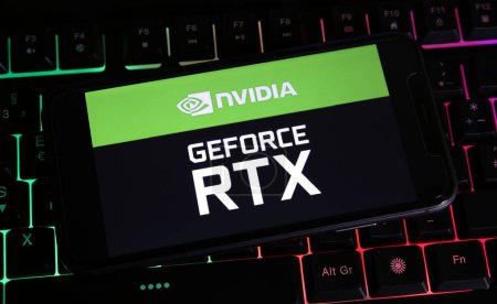 Photo for Viersen, Germany - January 9. 2024: Closeup of smartphone on pc keyboard with logo lettering of Nvidia Geforce RTX GPU - Royalty Free Image