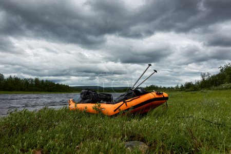Photo for Kiiruna, Sweden - July 19, 2022: Inflatable Kayak full gear and paddles by Lainio river in Swedish Lapland. - Royalty Free Image