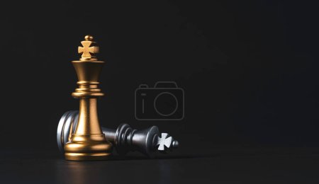 Stand of golden king chess and fallen silver king chess. Winner of business competition and marketing strategy planing concept.