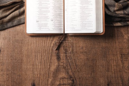 Photo for An open Bible on a wooden table, copyspace, flat lay bible - Royalty Free Image