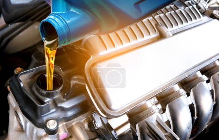 Photo for Refueling and pouring oil quality into the engine motor car Transmission and Maintenance Gear .Energy fuel concept. - Royalty Free Image